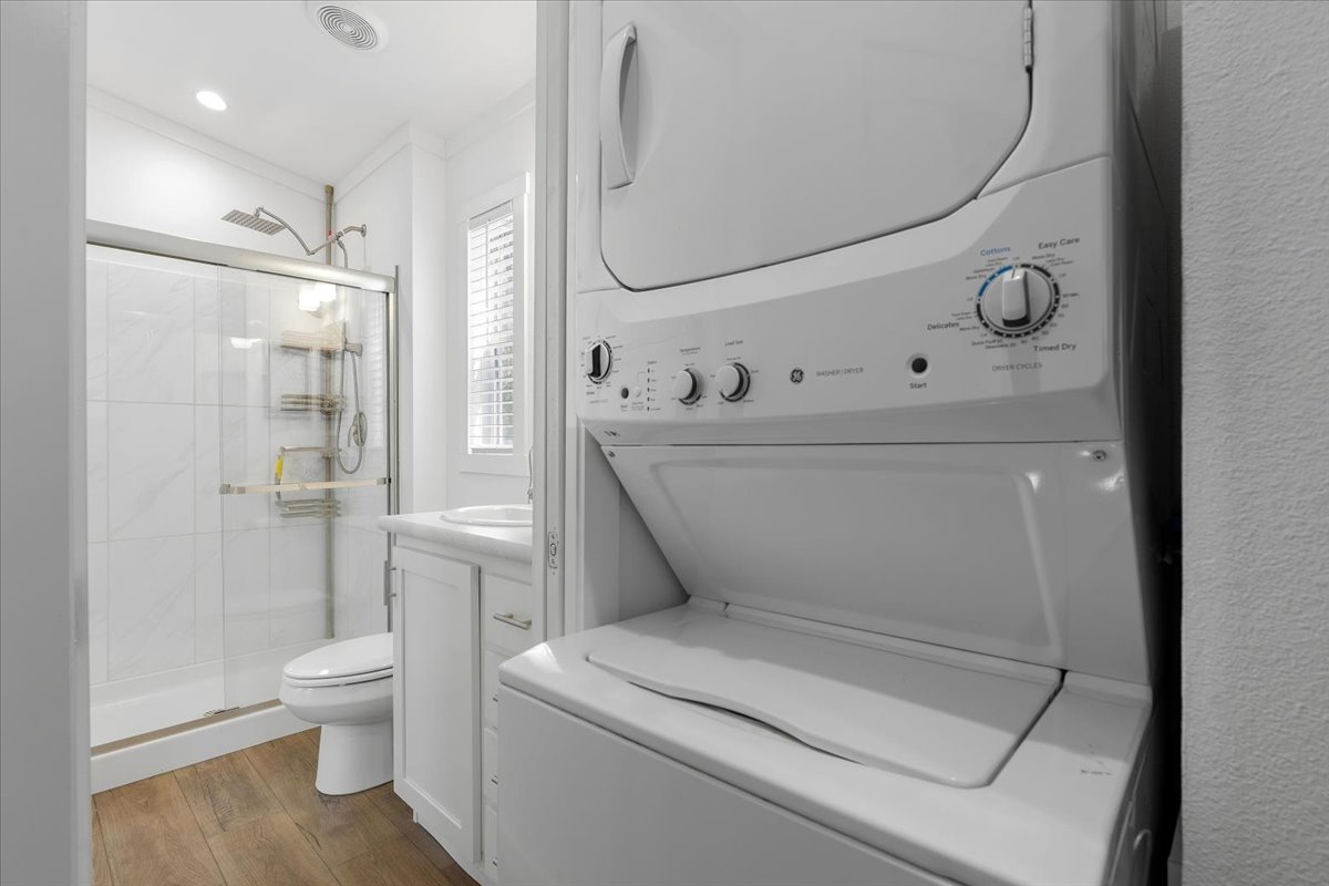 1705 Makinson Road West Point, TX 78963 - Photo 10 of 40 A well-appointed bathroom offers a practical stacked washer and dryer unit for ultimate convenience.