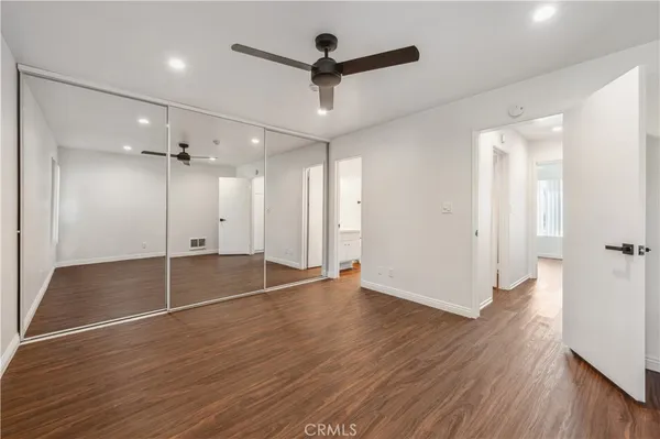 a view of empty room with wooden floor and fireplace