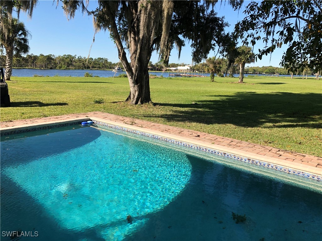 17720 Taylor Road Alva, FL 33920 - Photo 10 of 10 a view of a trees and yard with a swimming pool