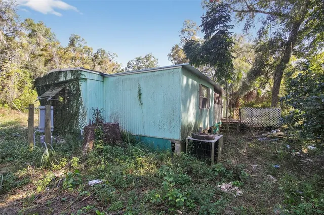 a view of a house with a yard and garden