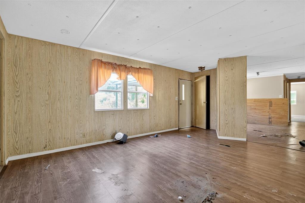 3140 Northeast 162 Place Citra, FL 32113 - Photo 7 of 30 a view of an empty room with wooden floor and a window