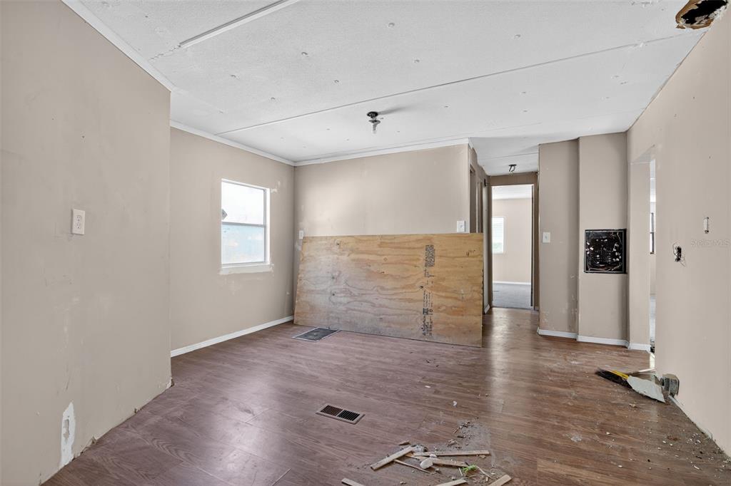 3140 Northeast 162 Place Citra, FL 32113 - Photo 8 of 30 an empty room with wooden floor and windows