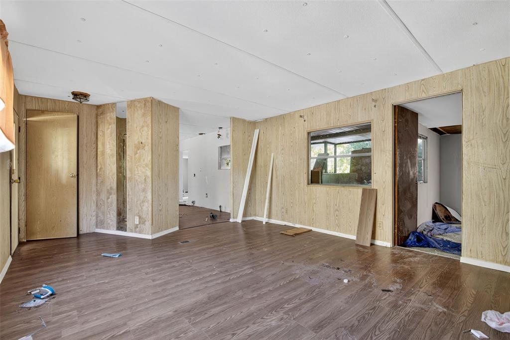 3140 Northeast 162 Place Citra, FL 32113 - Photo 9 of 30 a view of an empty room with wooden floor and a window
