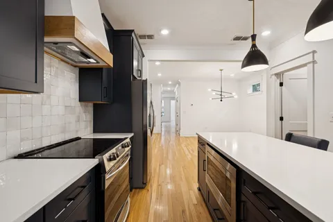 a kitchen with a sink appliances and cabinets