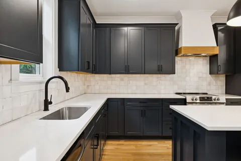 a kitchen with a sink cabinets and a stove