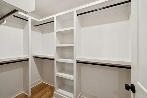 a view of walk in closet with empty racks