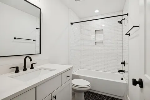 a bathroom with a sink mirror toilet and bathtub