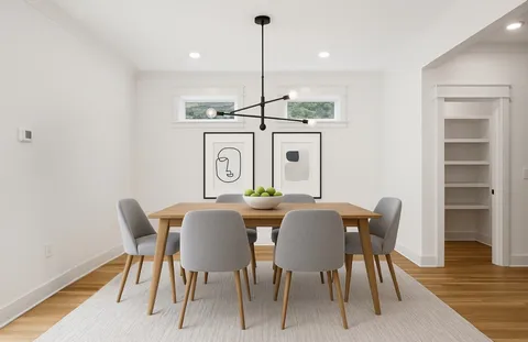 a view of a dining room with furniture wooden floor and chandelier