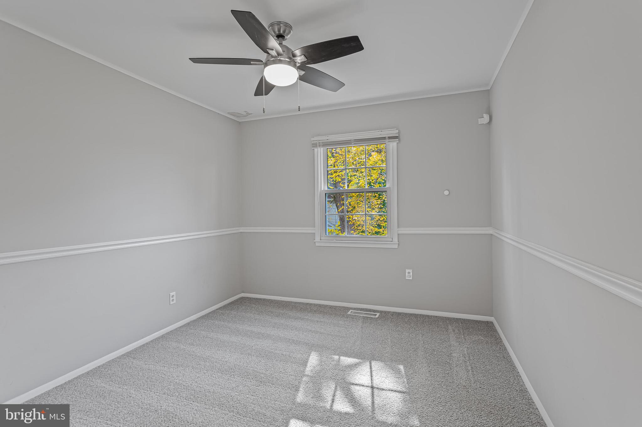 12027 Cheviot Drive Herndon, VA 20170 - Photo 17 of 29 an empty room with windows and ceiling fan
