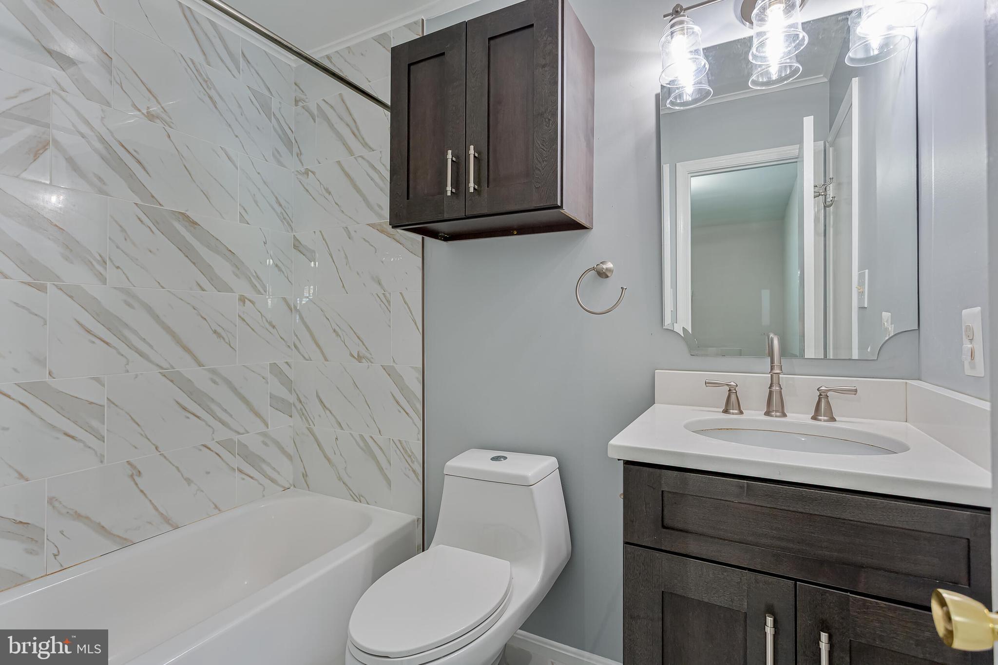 12027 Cheviot Drive Herndon, VA 20170 - Photo 20 of 29 a bathroom with a sink toilet and shower