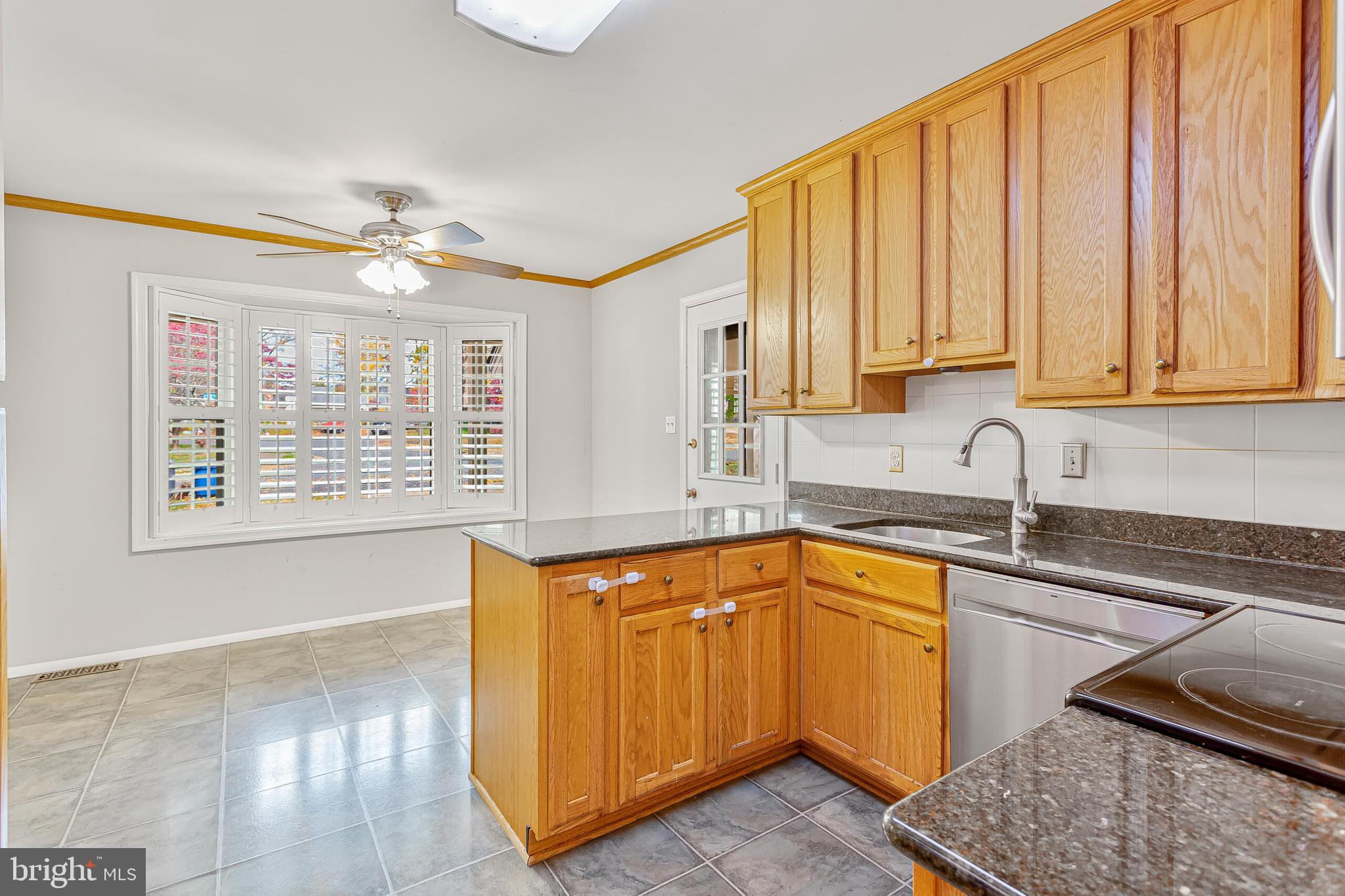 12027 Cheviot Drive Herndon, VA 20170 - Photo 5 of 29 a kitchen with stainless steel appliances granite countertop a sink and a white cabinets