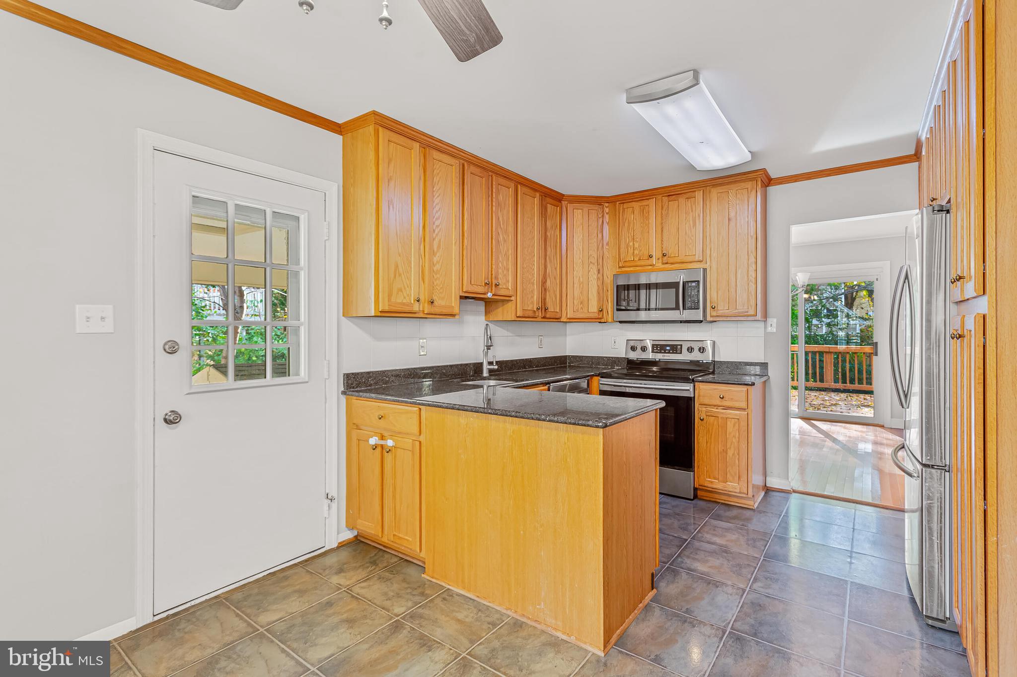 12027 Cheviot Drive Herndon, VA 20170 - Photo 6 of 29 a kitchen with stainless steel appliances granite countertop a stove a sink dishwasher a refrigerator and a microwave oven with white cabinets