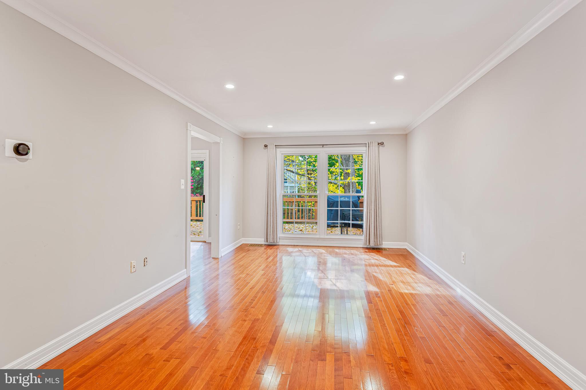 12027 Cheviot Drive Herndon, VA 20170 - Photo 9 of 29 a view of an empty room with wooden floor and a window