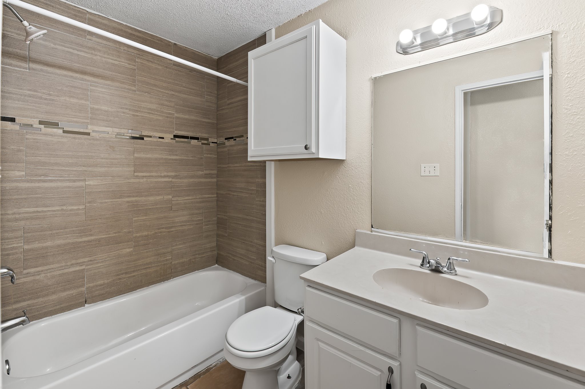410 Old Thorndale Road, Unit D Taylor, TX 76574 - Photo 14 of 14 Bathroom featuring a white vanity with an integrated sink, polished chrome faucet, and a large wall-mounted mirror