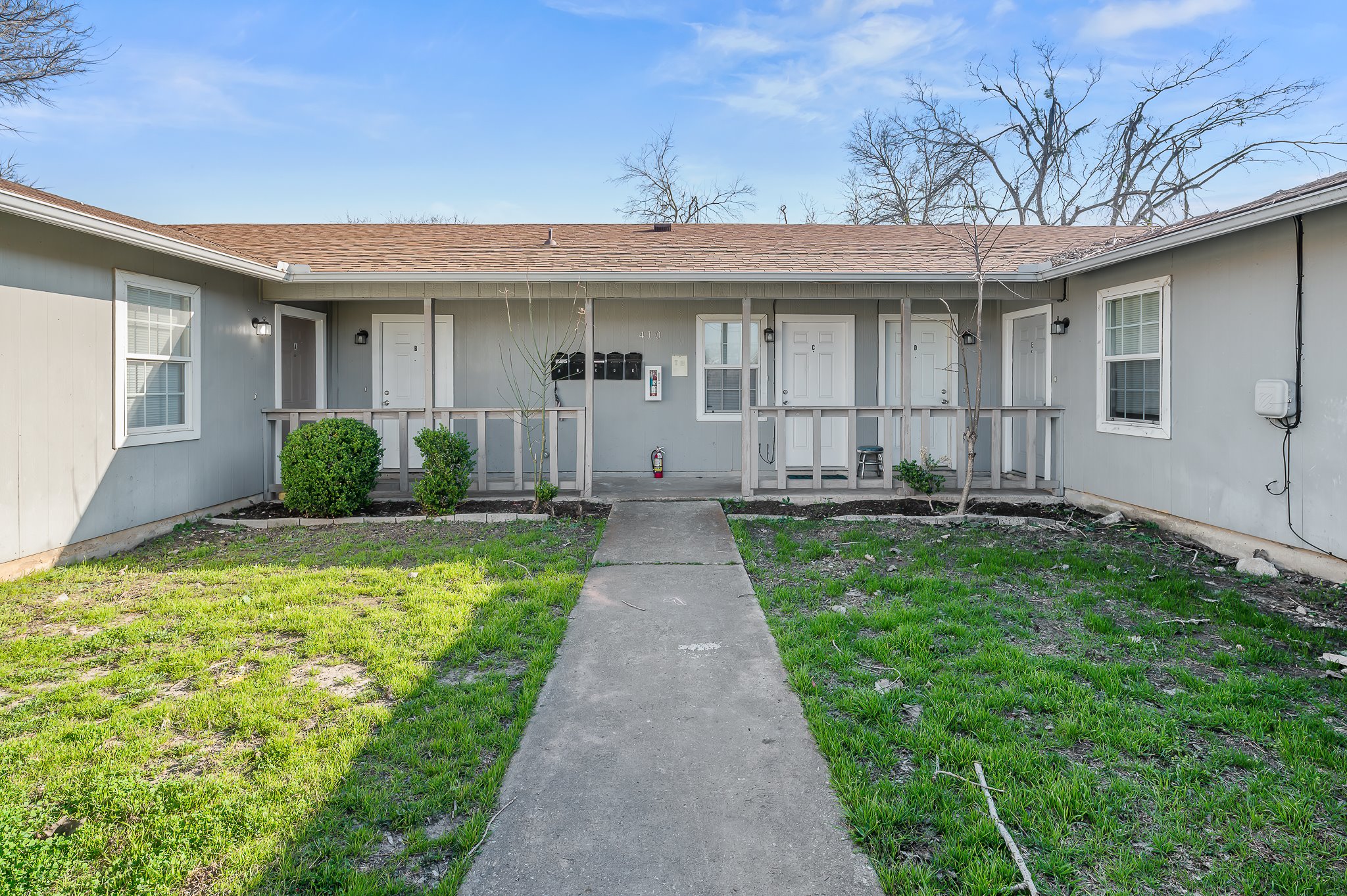 410 Old Thorndale Road, Unit D Taylor, TX 76574 - Photo 4 of 14 Light gray exterior with white trim windows and entry doors
