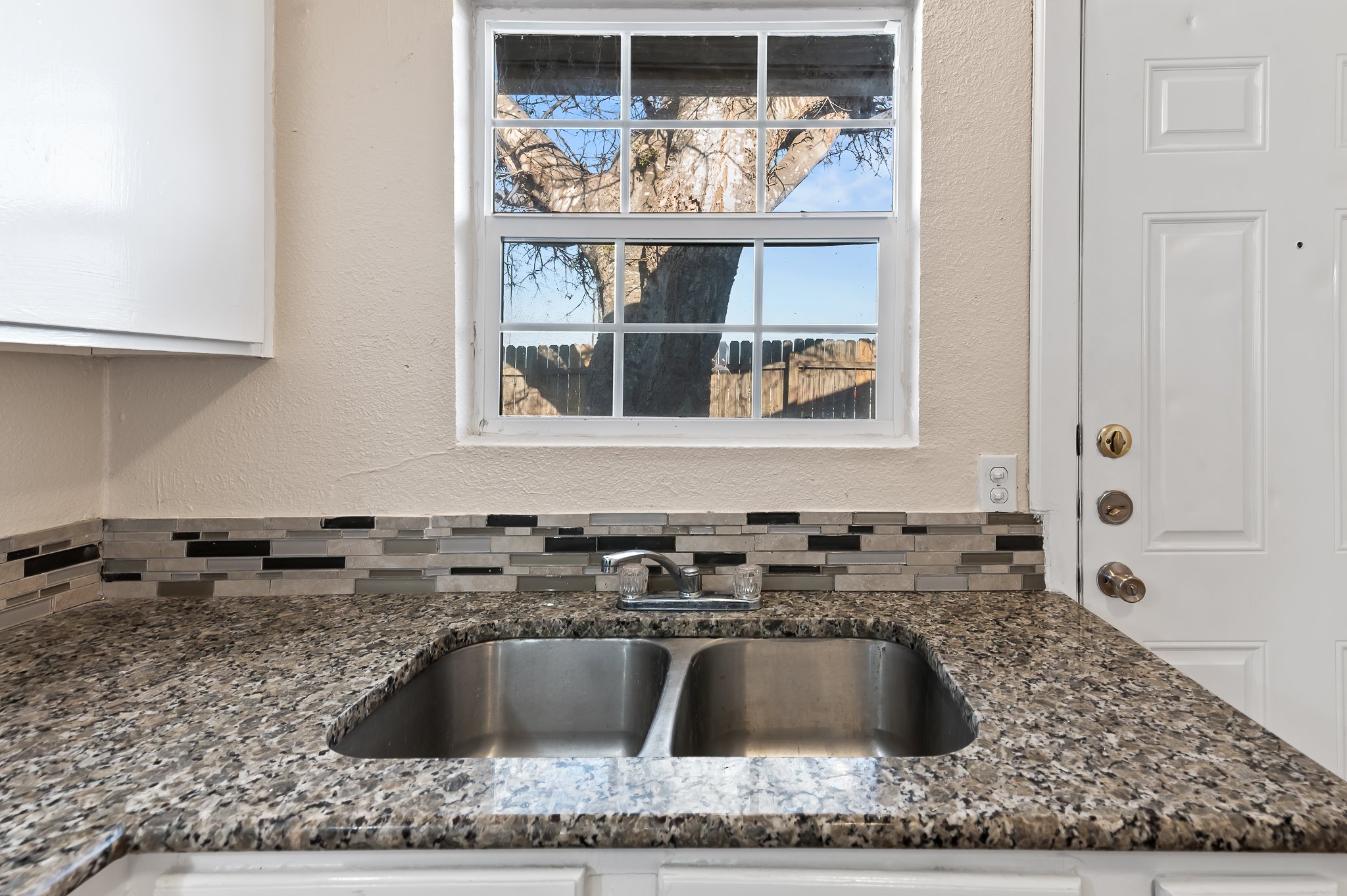 410 Old Thorndale Road, Unit D Taylor, TX 76574 - Photo 10 of 14 Kitchen area featuring a double basin stainless steel sink with a chrome faucet
