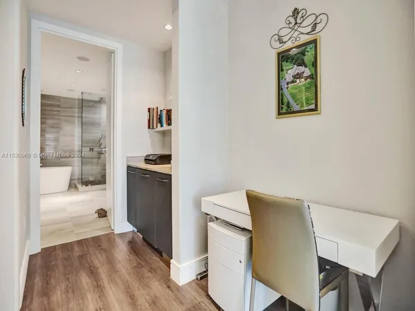 a bedroom with a bed and a television