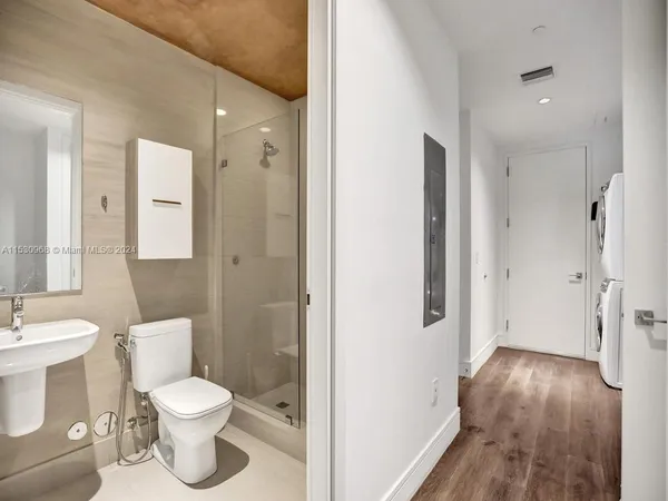 a view of a hallway with closet and wooden floor
