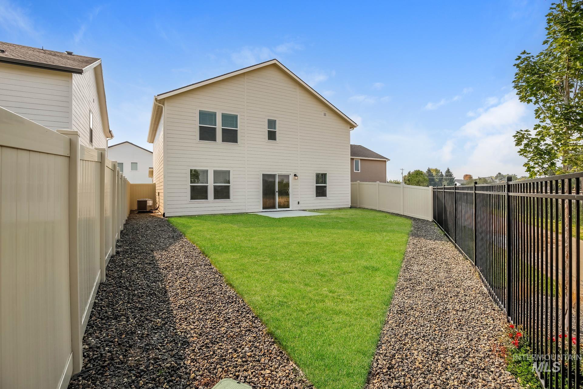 1918 East Springloyd Street Meridian, ID 83642 - Photo 20 of 20 Spacious backyard featuring a manicured lawn, a concrete patio, and a vinyl privacy fence