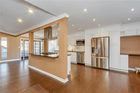 a kitchen with stainless steel appliances refrigerator oven and cabinets