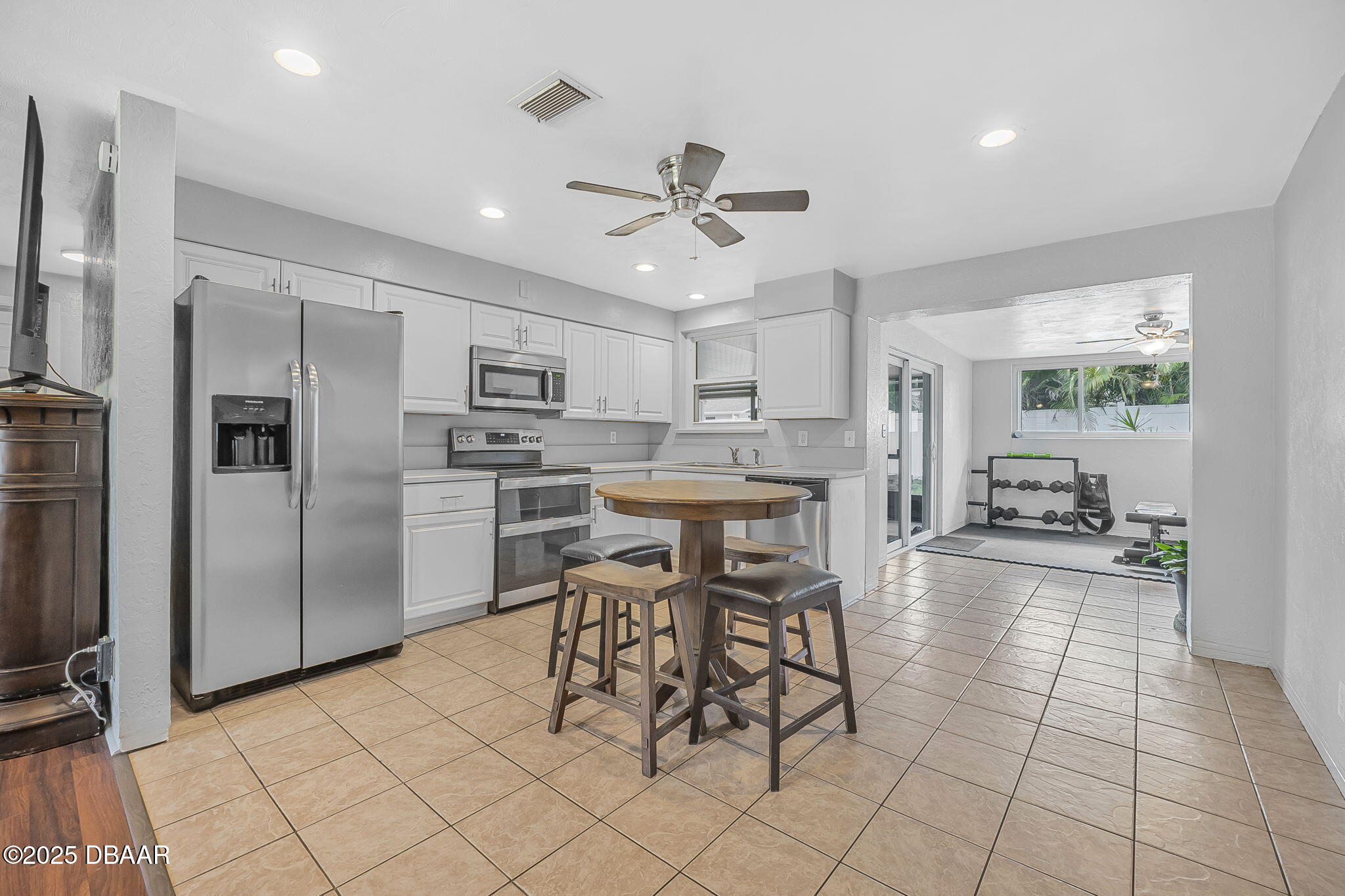 737 5th Street Port Orange, FL 32129 - Photo 13 of 40 a kitchen with stainless steel appliances kitchen island granite countertop a refrigerator and microwave