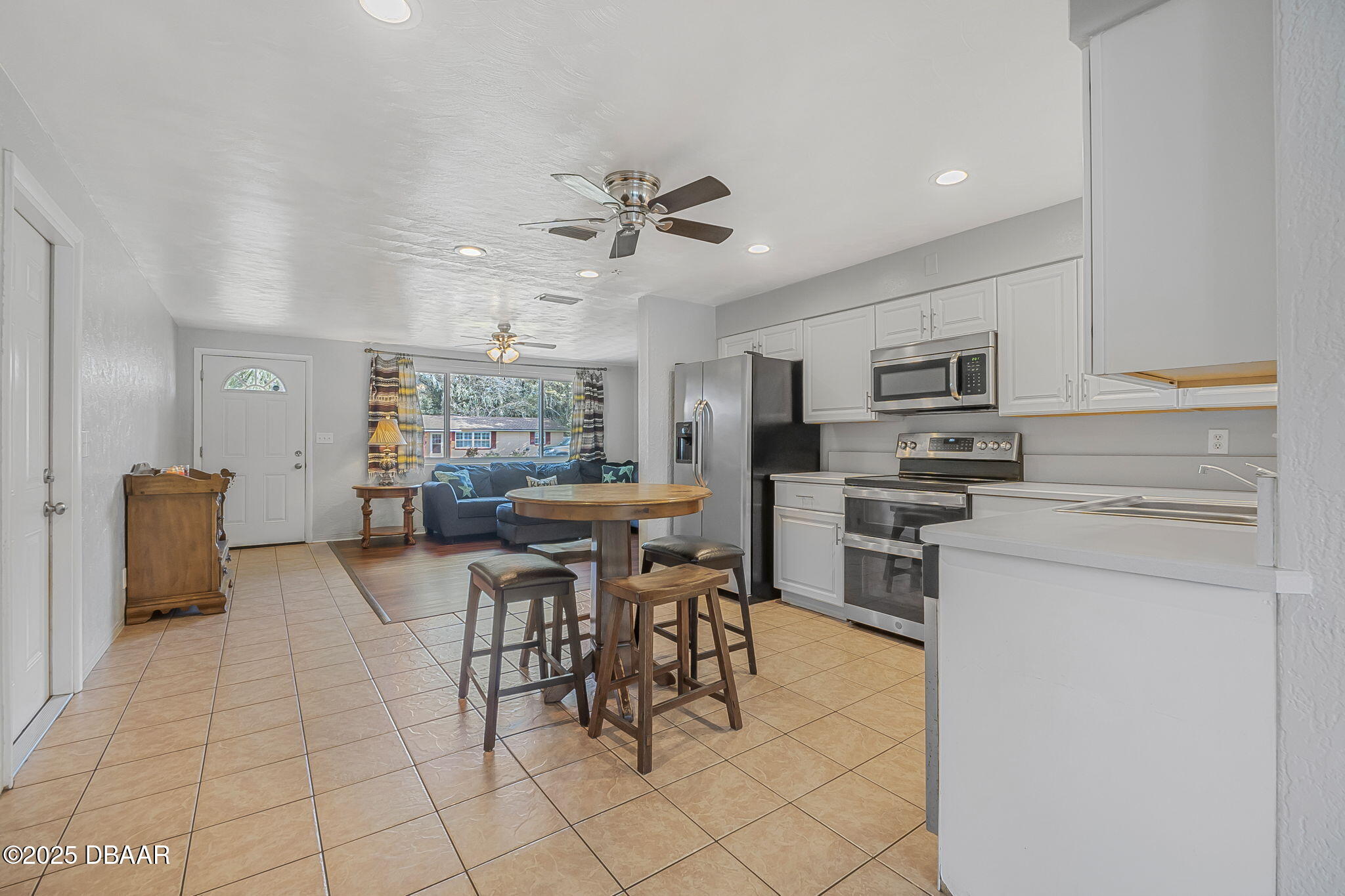 737 5th Street Port Orange, FL 32129 - Photo 14 of 40 a kitchen with stainless steel appliances kitchen island granite countertop a sink and cabinets