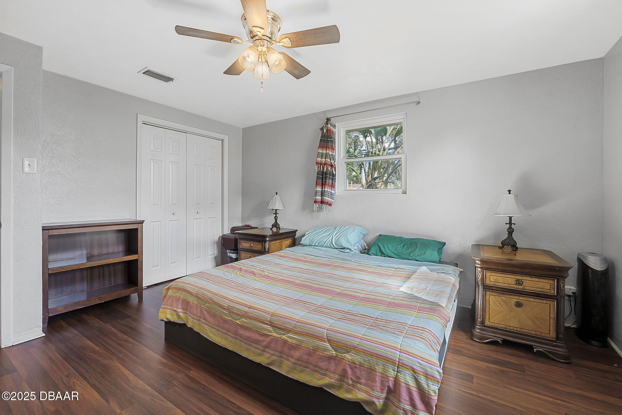737 5th Street Port Orange, FL 32129 - Photo 18 of 40 a bedroom with a bed and a chandelier