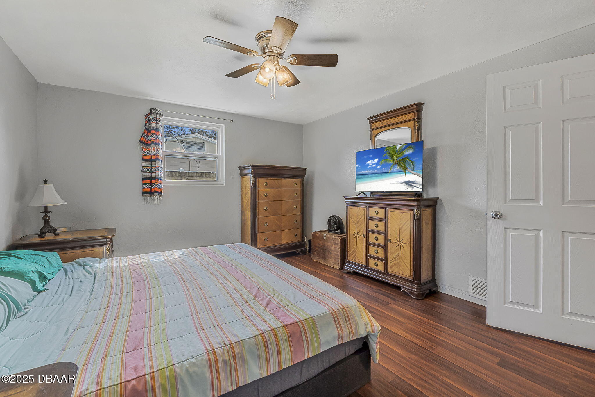 737 5th Street Port Orange, FL 32129 - Photo 19 of 40 a bedroom with a bed and a chandelier