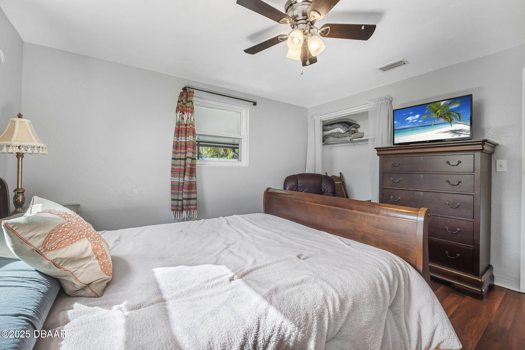 737 5th Street Port Orange, FL 32129 - Photo 22 of 40 a bedroom with a bed and a tv on the dresser