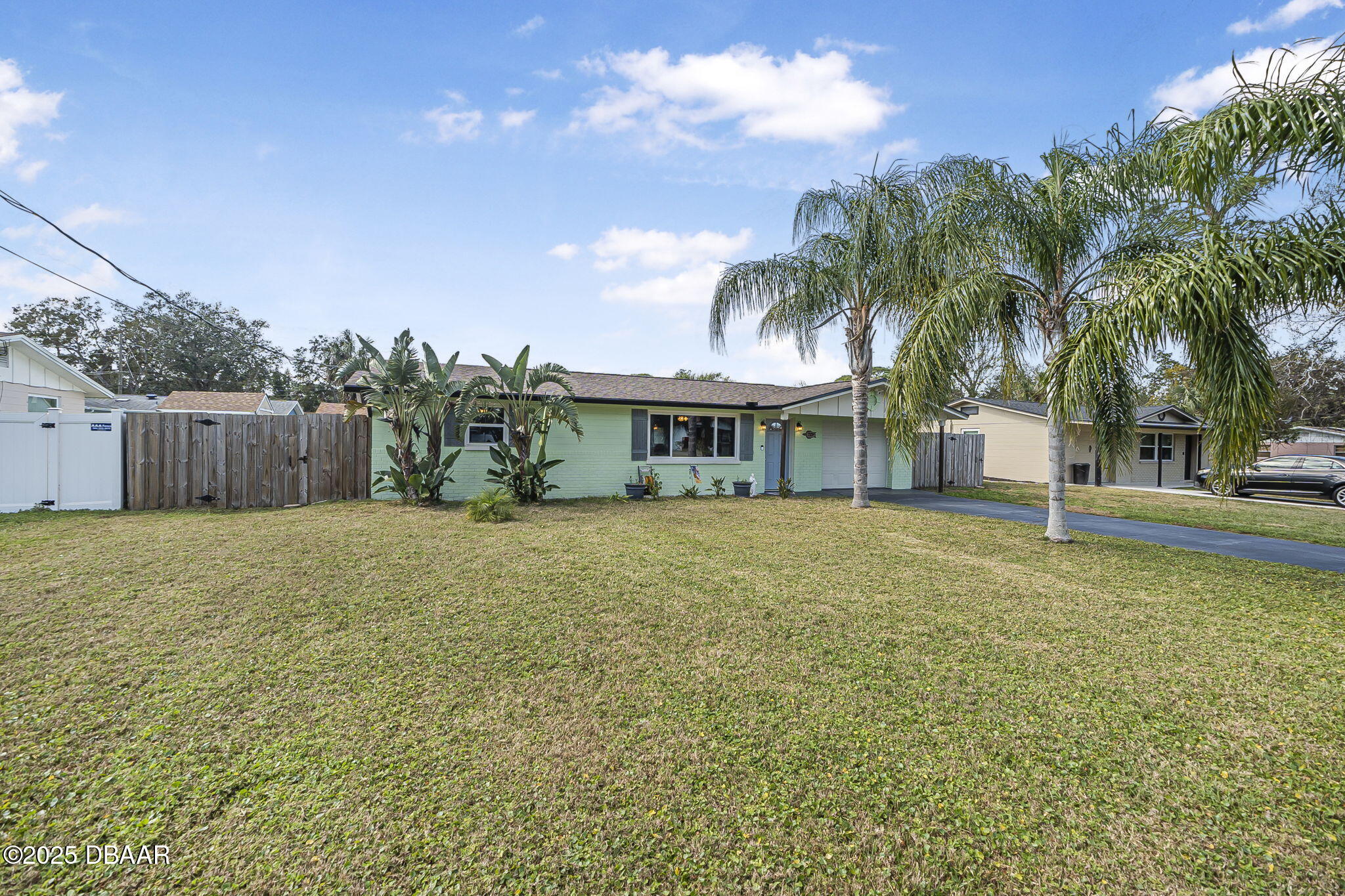 737 5th Street Port Orange, FL 32129 - Photo 3 of 40 a view of a house with a backyard and a tree
