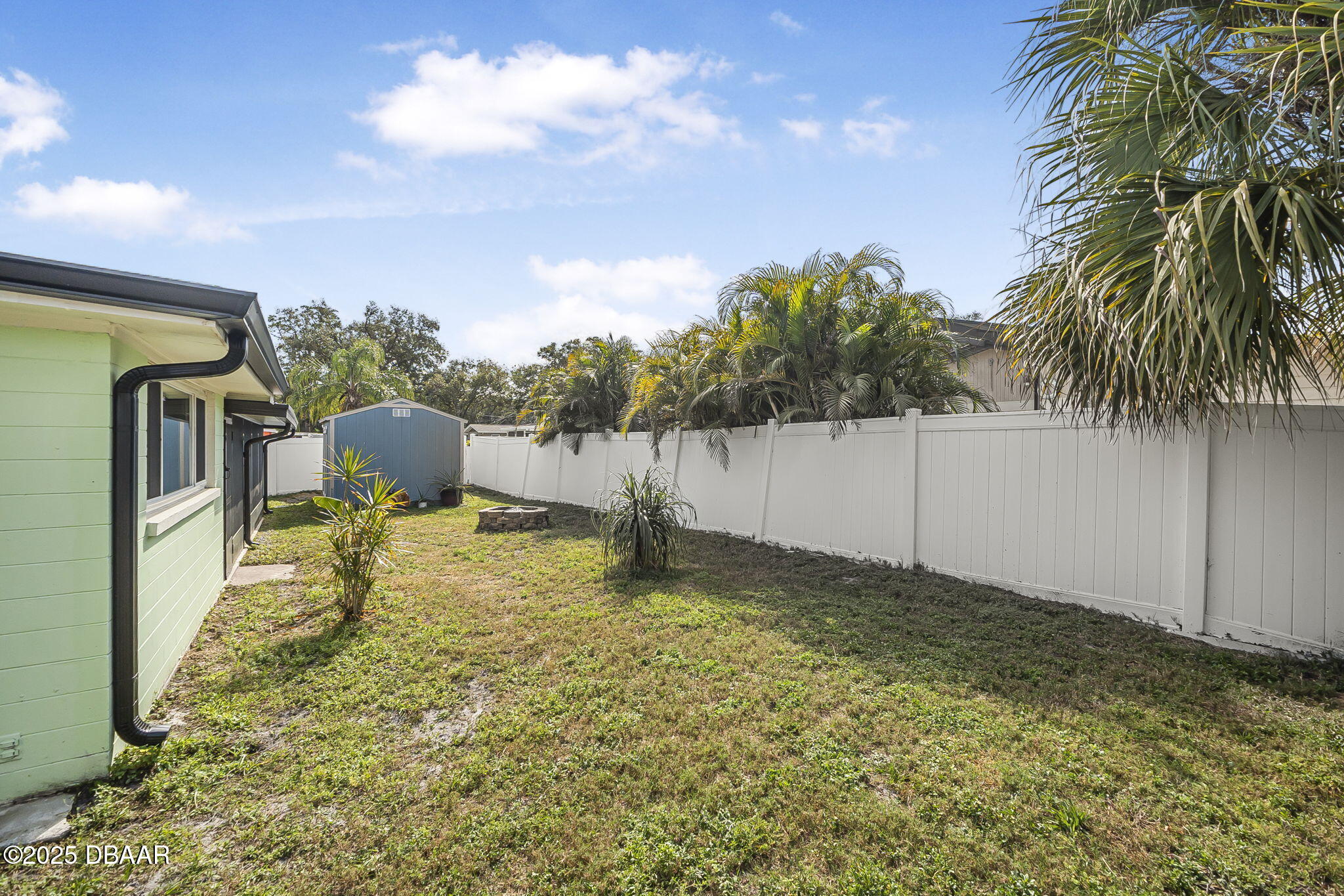 737 5th Street Port Orange, FL 32129 - Photo 36 of 40 a backyard of a house with table and chairs