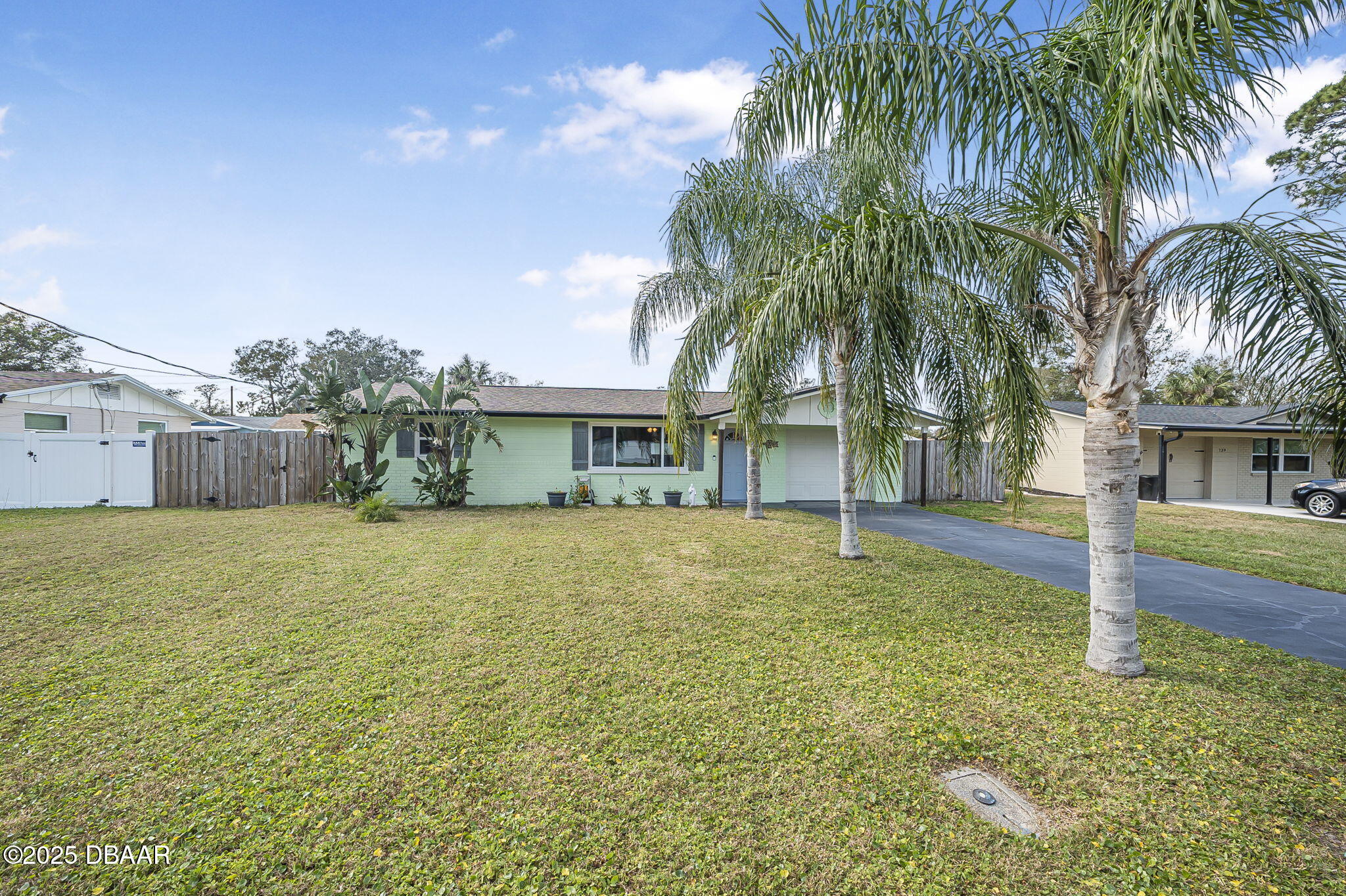 737 5th Street Port Orange, FL 32129 - Photo 4 of 40 a front view of a house with a garden