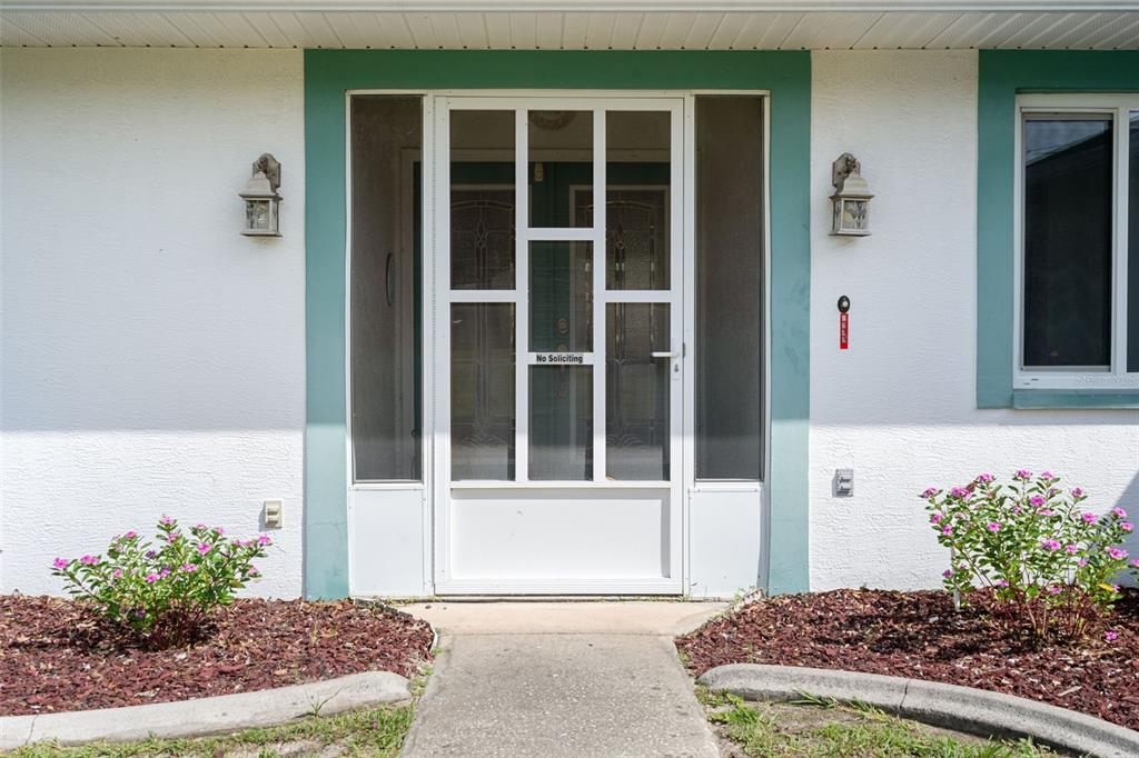5035 Harbinger Road Spring Hill, FL 34608 - Photo 10 of 47 a front view of a house with a yard