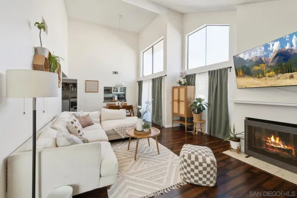 a living room with furniture a fireplace and a flat screen tv