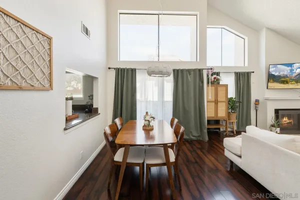 a living room with furniture a fireplace and a window