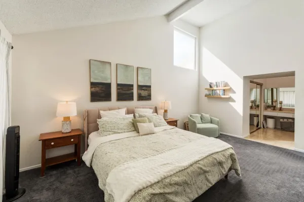 a bedroom with a bed and a view of kitchen