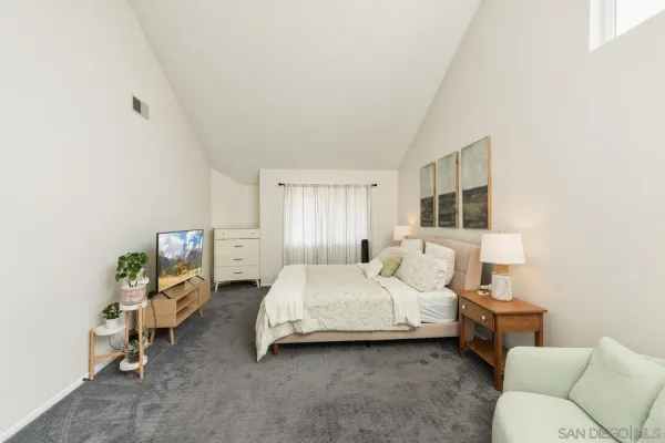 a bedroom with a bed and a couch