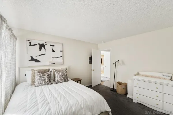 a bedroom with a bed and a dresser