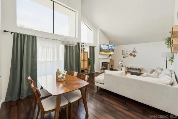 a living room with furniture a table and chairs