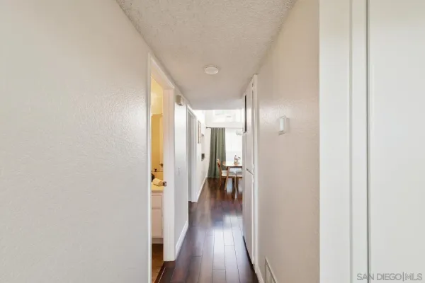 a view of a hallway with wooden floor