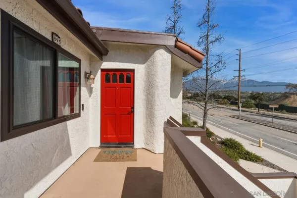 a view of a house with a balcony and door