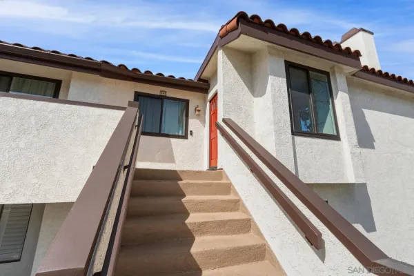 a view of a house with a door and a yard