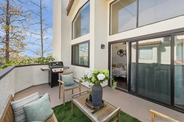 a balcony with table and chairs