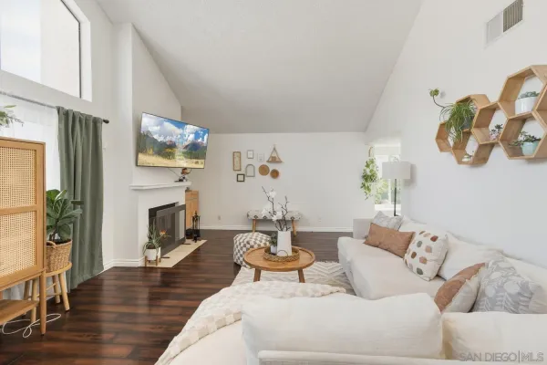 a living room with furniture a fireplace and a flat screen tv