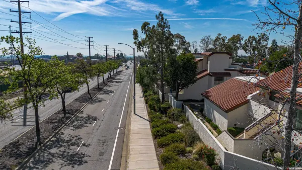 an aerial view of a house with backyard and deck