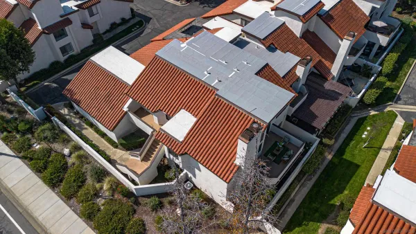 an aerial view of residential houses with outdoor space