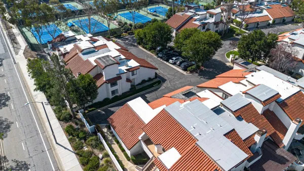 an aerial view of residential houses with outdoor space
