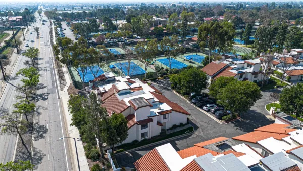an aerial view of residential houses with outdoor space