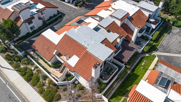 an aerial view of multiple houses with a yard