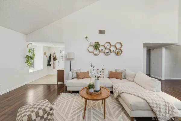 a living room with furniture and a wooden floor